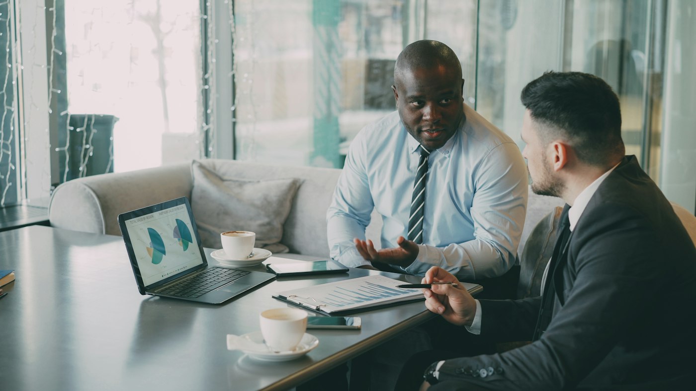 Two advisers reviewing charts on a laptop