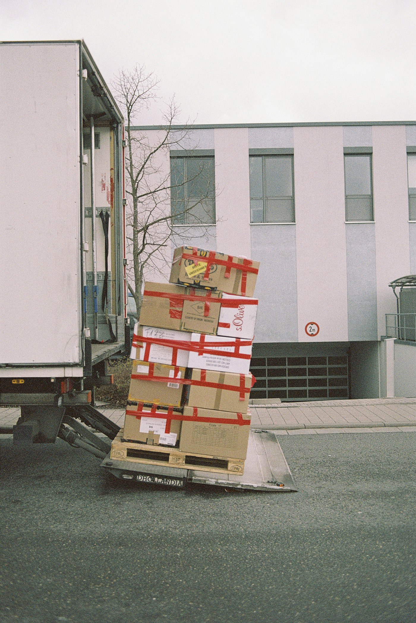 Boxes on a pallet beside a moving truck